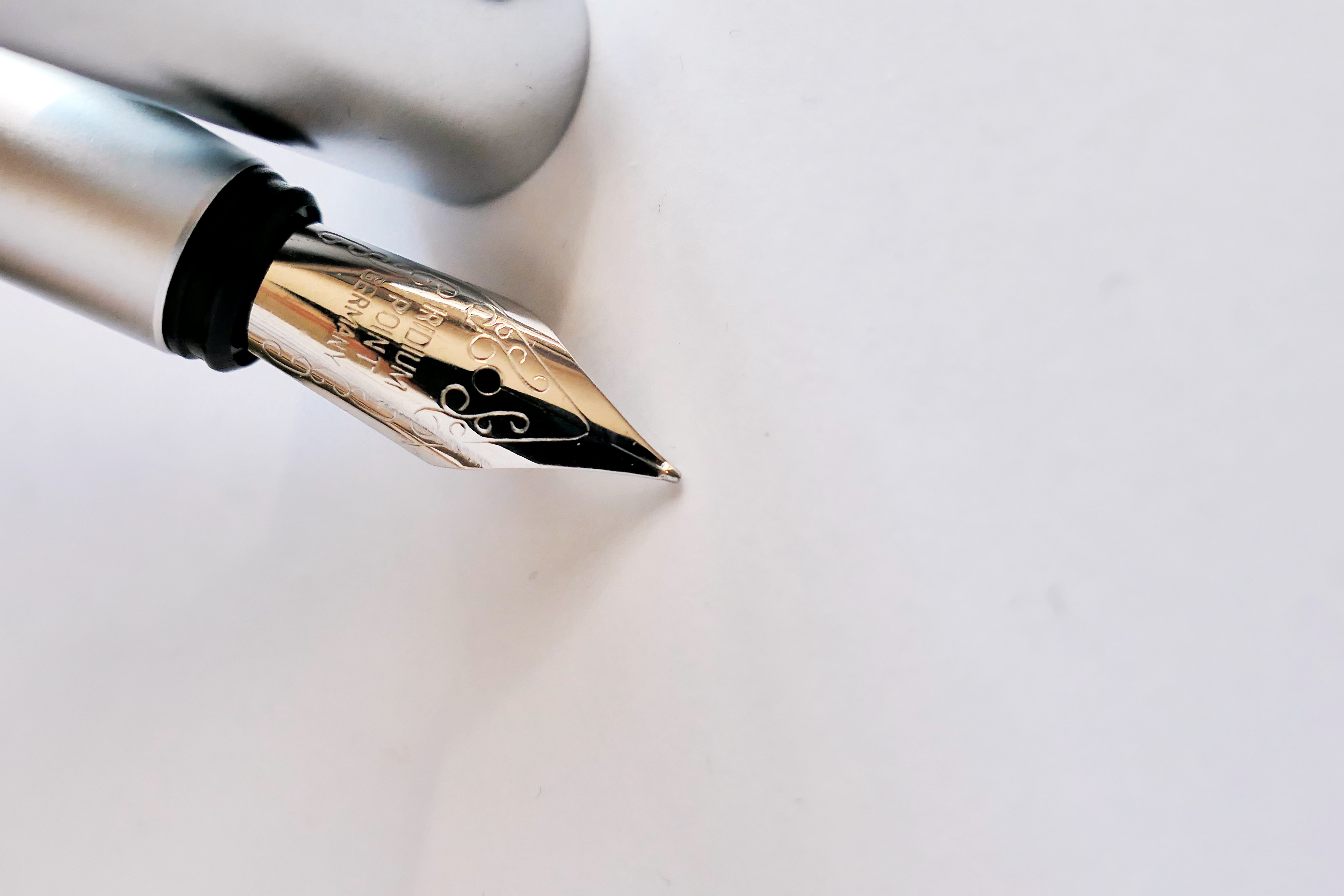 fountain pen against a blank sheet of paper